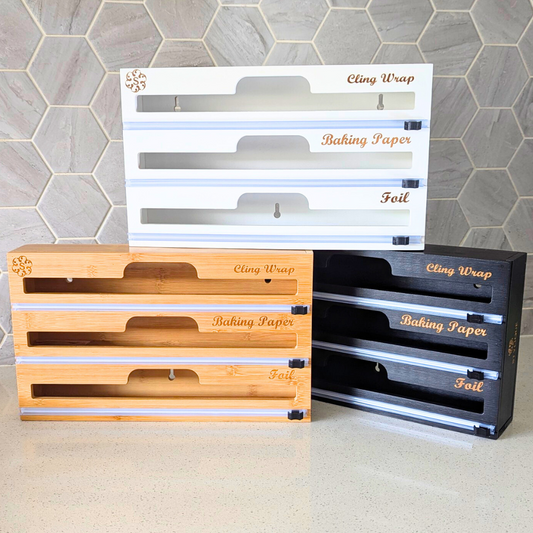 STYLIQUE bamboo 3-in-1 dispenser holding cling wrap, foil and baking paper with a built-in cutter
