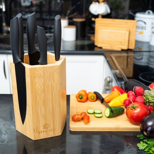 STYLIQUE bamboo magnetic knife holder styled on the benchtop of a small modern kitchen