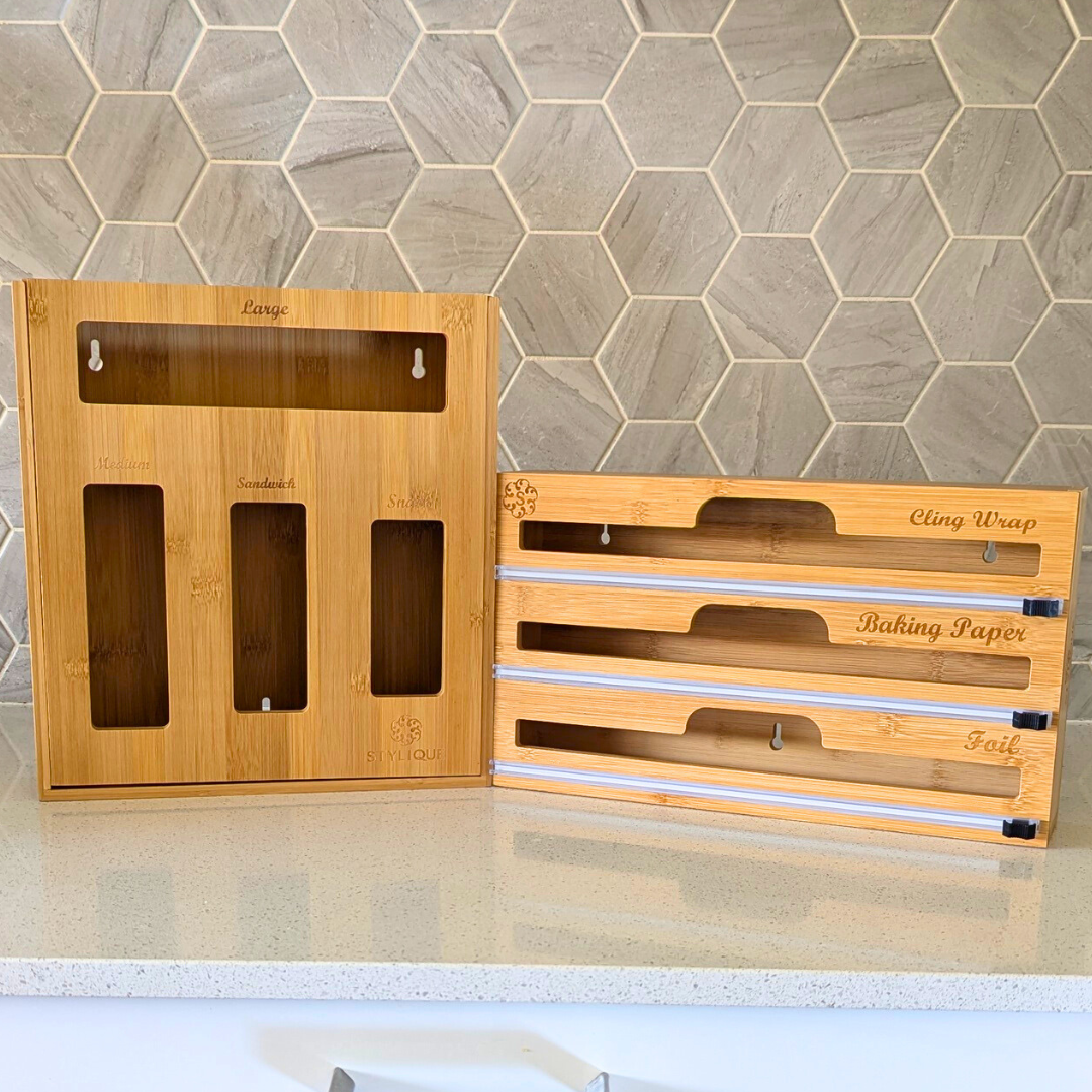 Bamboo kitchen organisers arranged on a benchtop, including bag organisers and a wrap dispenser