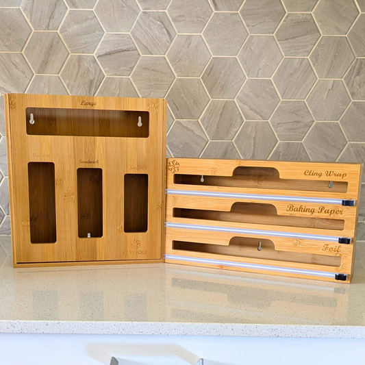 Bamboo kitchen organisers arranged on a benchtop, including bag organisers and a wrap dispenser