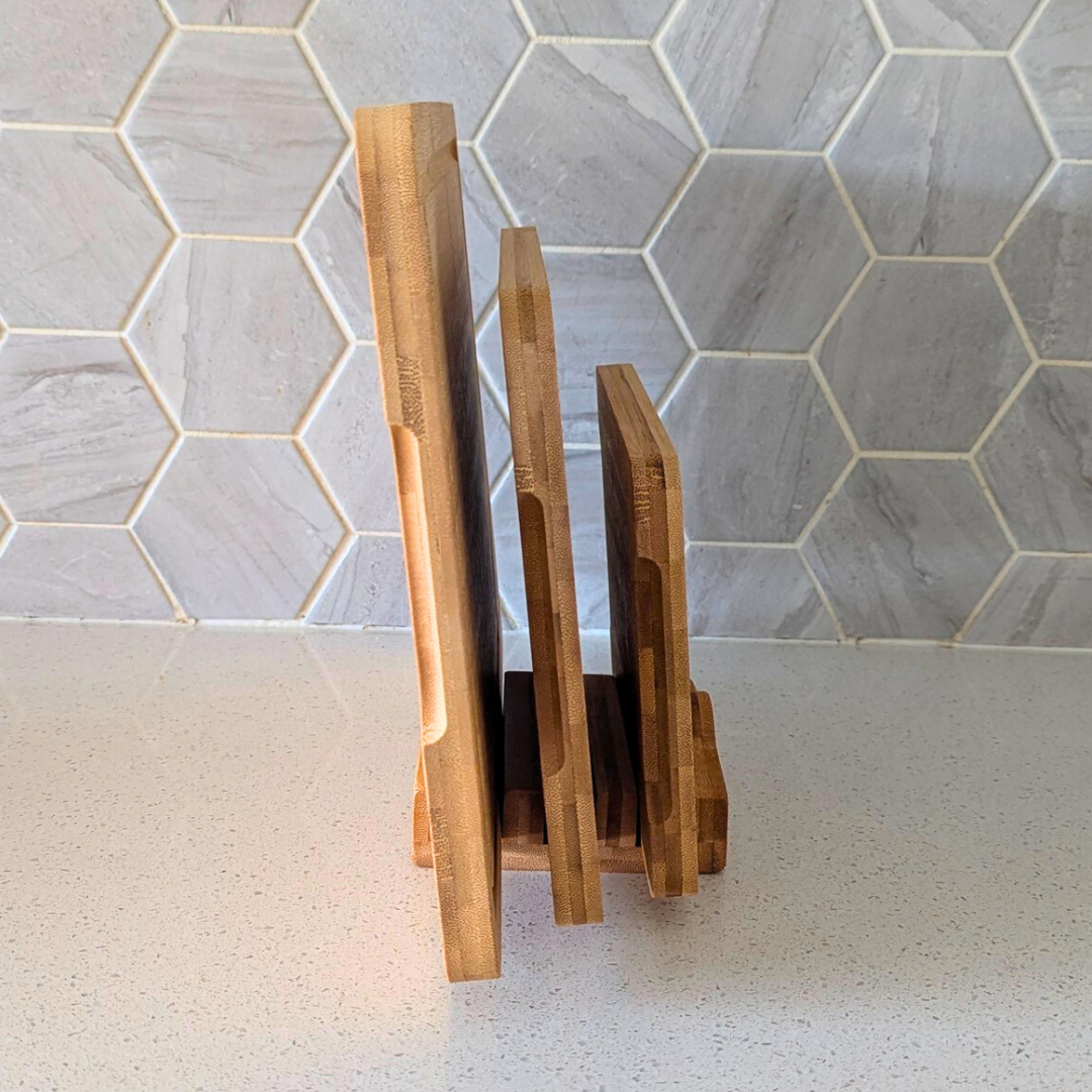 STYLIQUE bamboo chopping board set stored upright in its stand, showing the laminated edge grain